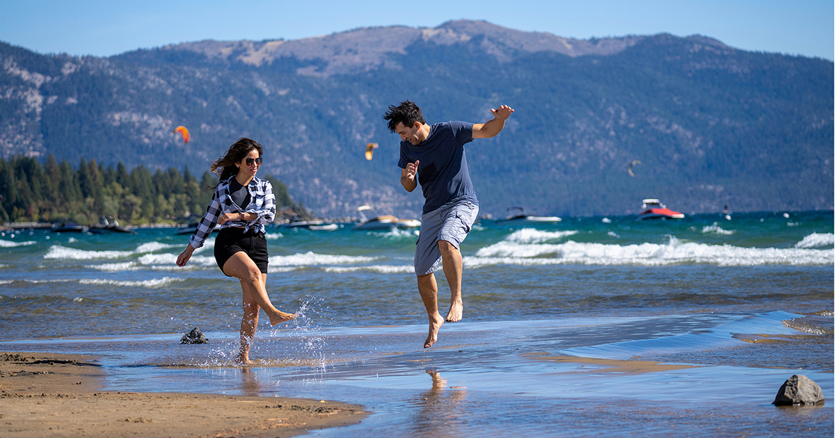 Two people on a beach at Lake Tahoe