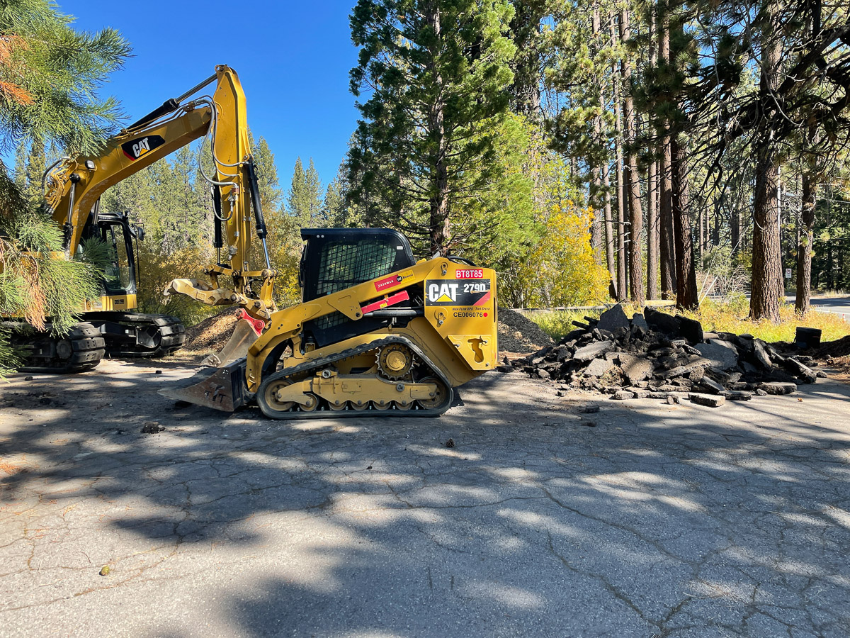 Construction equipment tearing up asphalt