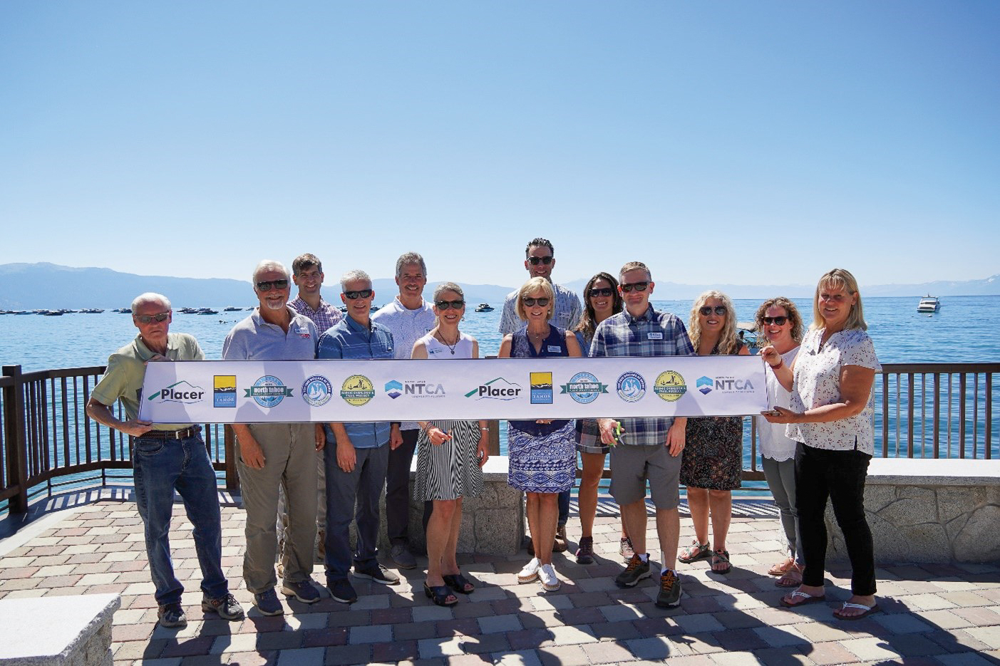 Local, state, and regional leaders gather to cut the ribbon to celebrate accessibility improvements at a Lake Tahoe waterfront recreation area.