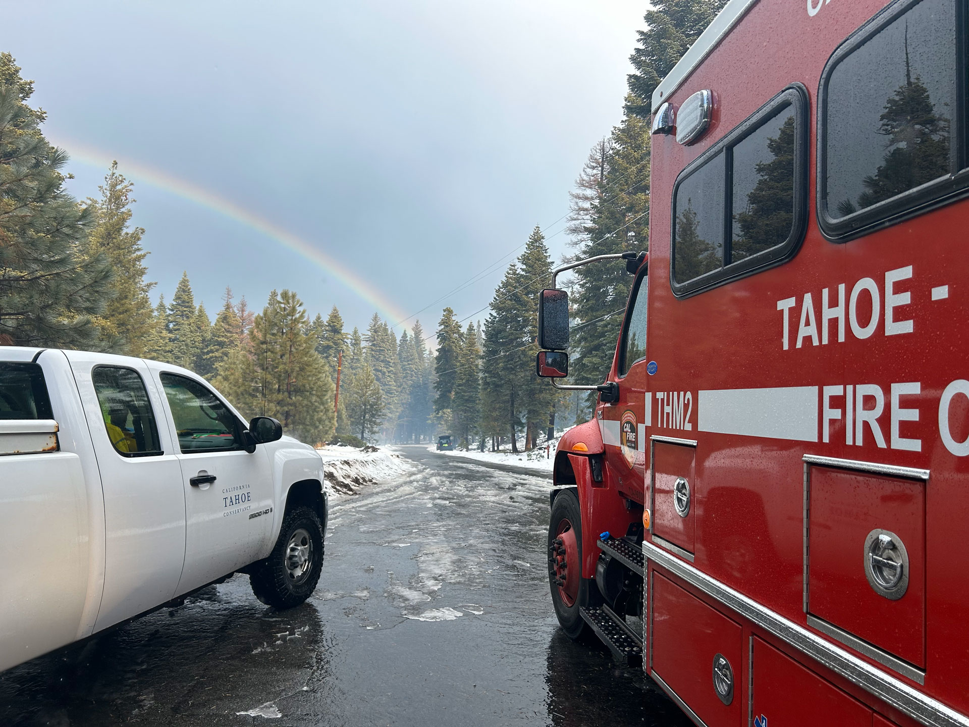 A CAL FIRE crew vehicle next to a California Tahoe Conservancy truck