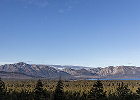Lake Tahoe with mountains behind and blue sky above