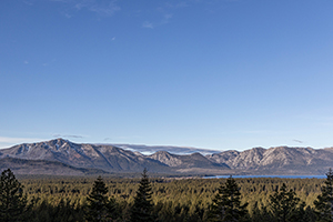 Lake Tahoe with mountains behind and blue sky above