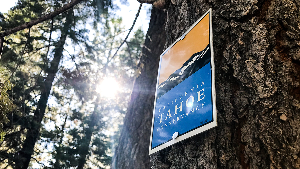 A California Tahoe Conservancy sign on a tree